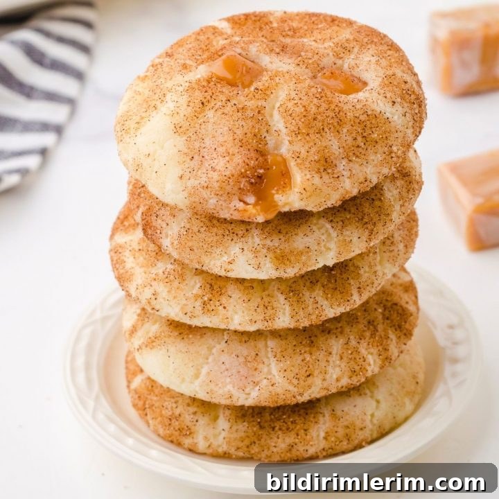 caramel snickerdoodle cookies stacked on a small white plate