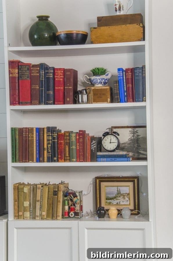 Cottagecore Winter Room Ideas for Warm, Inviting Spaces 6 A great way to add style to a cottage core room is to add vintage items to a bookcase - like vintage books, stoneware and fairy lights.