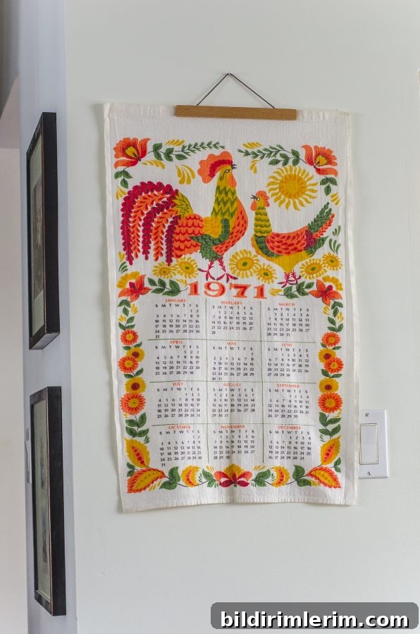 Cottagecore Winter Room Ideas for Warm, Inviting Spaces 7 A dishtowel calendar with roosters from 1971 with the colors orange, mustard yellow and sage green. It's perfectly at home in a cottage core room!