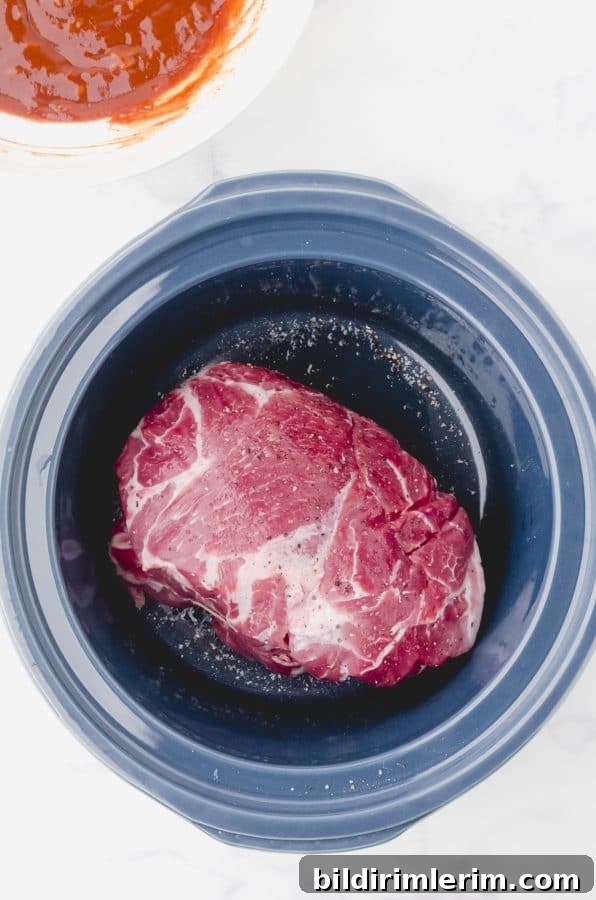 Crock Pot Pulled Pork Recipe: Tender, Juicy BBQ Flavor 5 Pork roast in the bottom of a crock pot for this pulled.pork recipe