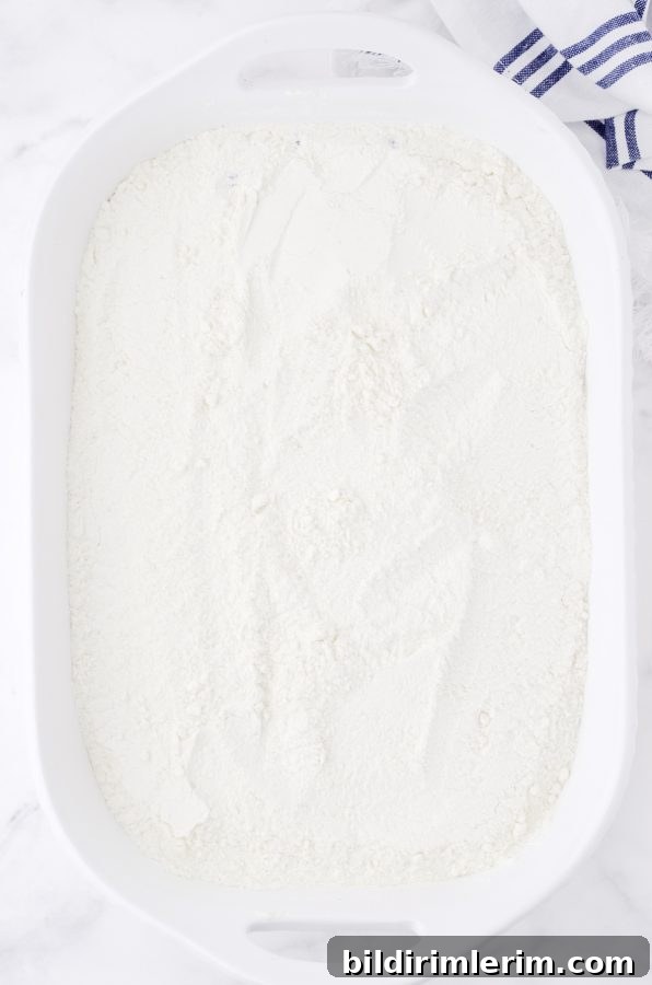 Lemon cake mix powder sprinkled over top of blueberry pie filling.