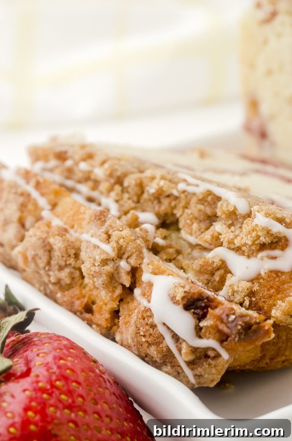 Slices of strawberry bread with a drizzle of vanilla glaze.