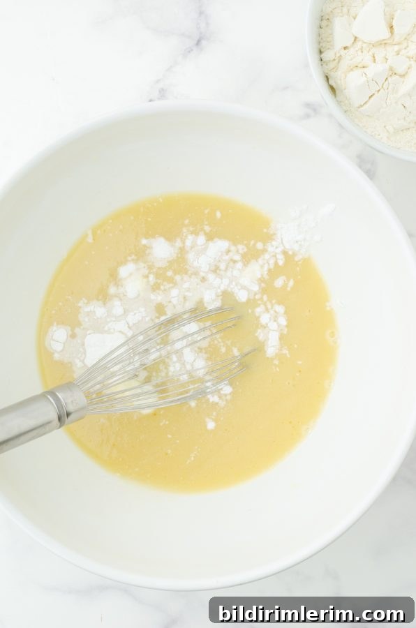 baking powder and salt sprinkled on batter ready to whisk in for strawberry quick bread