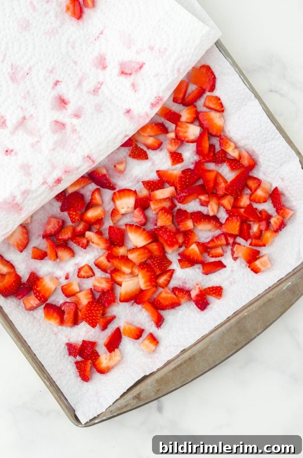 fresh strawberries diced and placed on a tray with paper towel