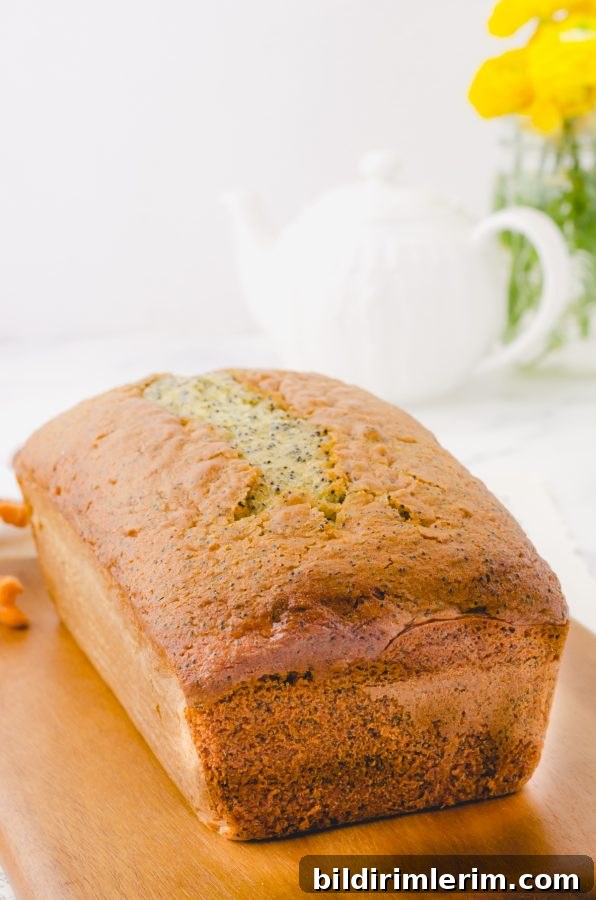 A loaf of poppyseed bread with cake mix on a cutting board