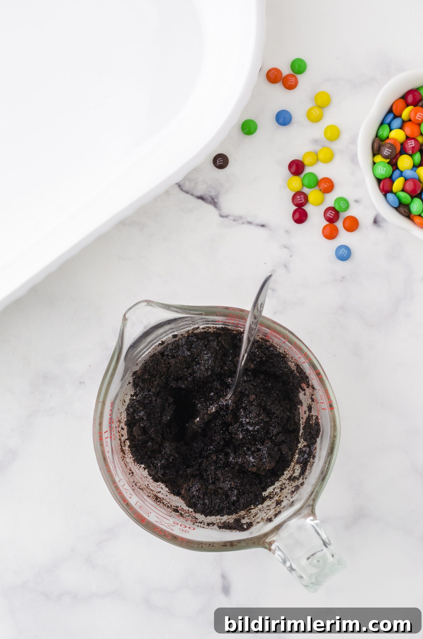 How to Make Oreo Ice Cream Cake with Oreo Crust 4 ingredients for oreo crust mixed in a large measuring cup