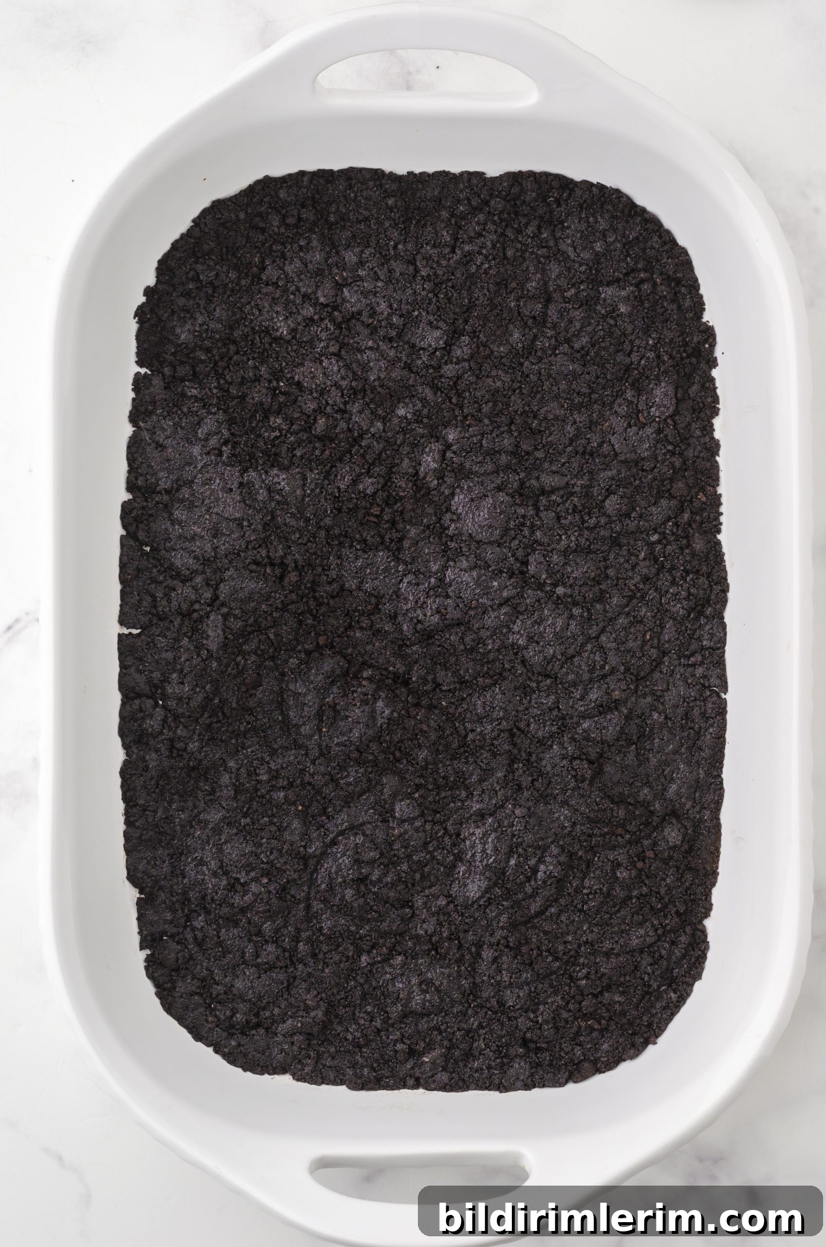 How to Make Oreo Ice Cream Cake with Oreo Crust 5 the oreo crust for oreo ice cream cake pressed into a 9 x 13 inch pan.
