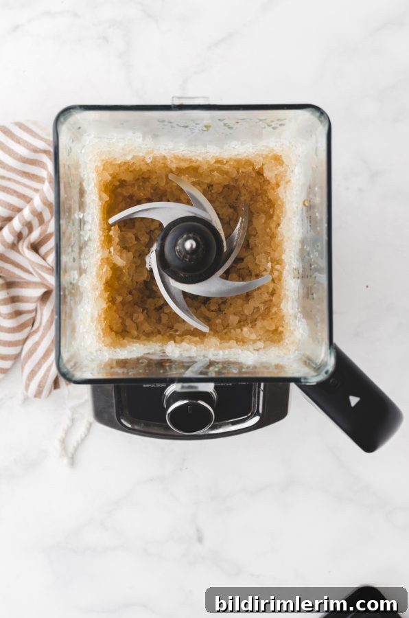 Nescafe Frappe Recipe: Iced Coffee with Espresso Powder 7 Milk and vanilla being added to the blended coffee mixture
