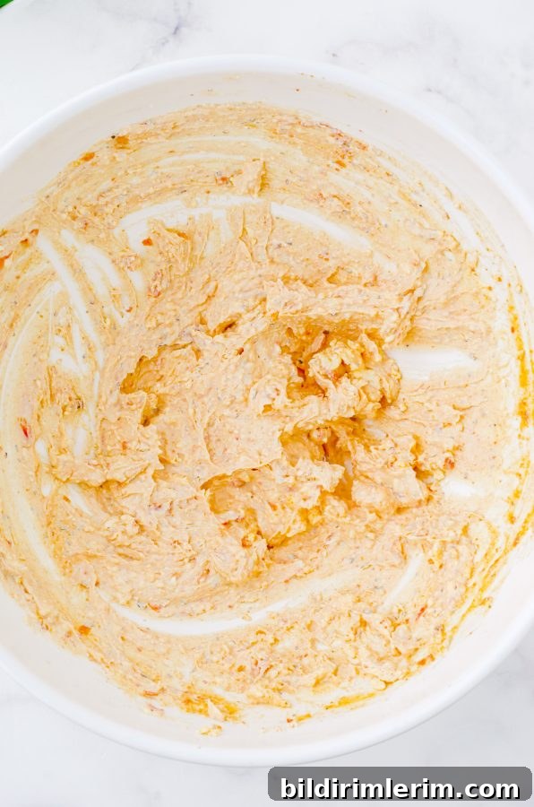 Sundried tomato sauce in a medium bowl after it has been mixed together.