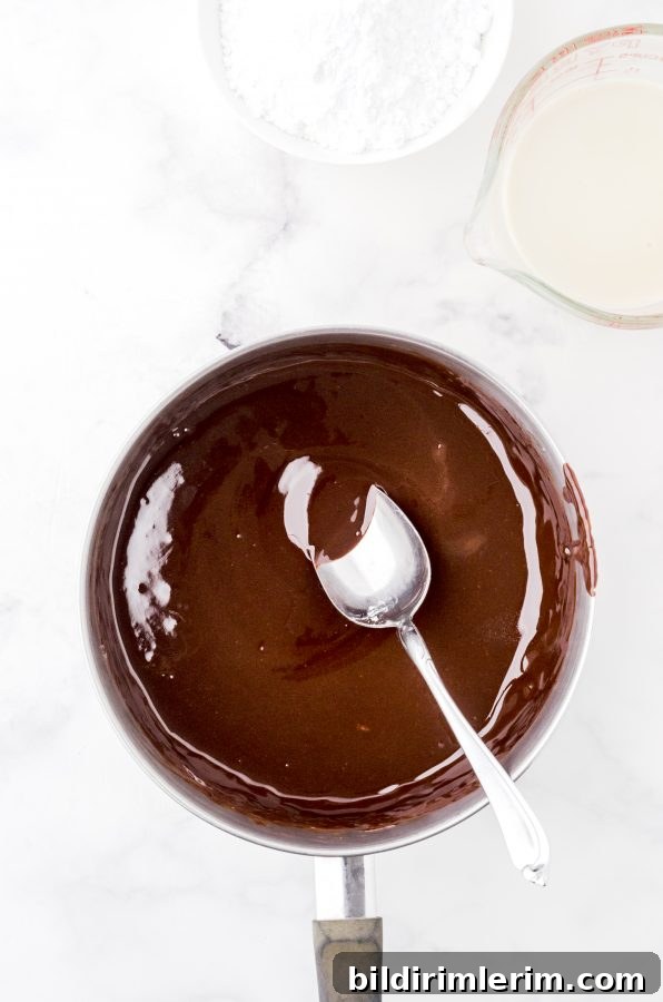 Melted chocolate chips and butter in a saucepan - step 1 for homemade hot fudge sauce