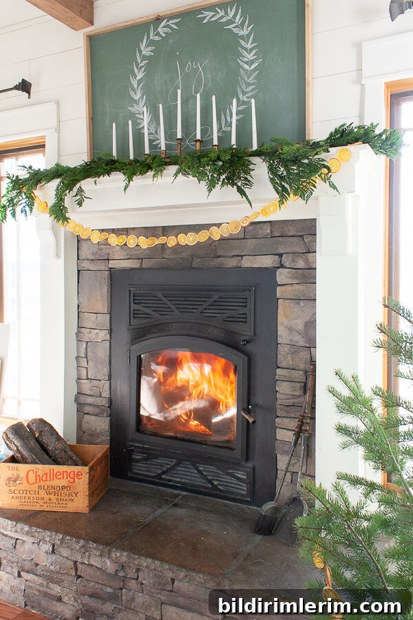 Dried orange slices strung to make a garland and hung on a fireplace mantel