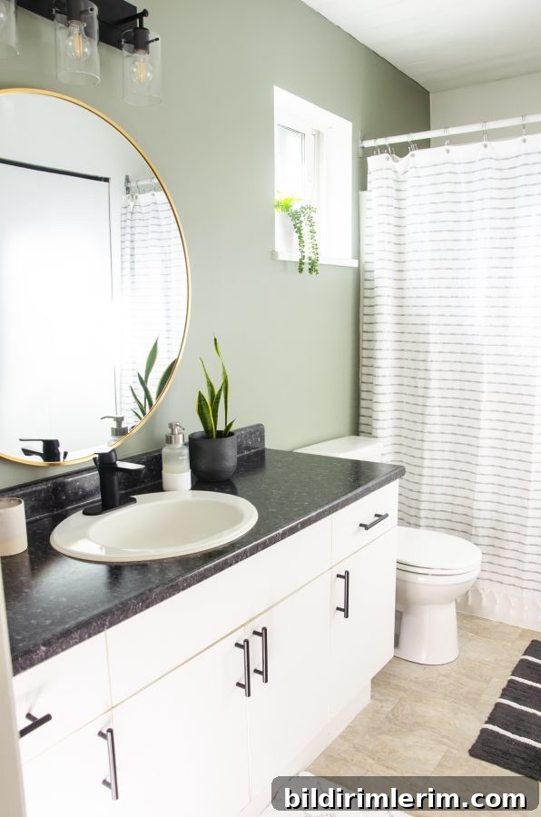 Evergreen Fog Bathroom Remodel: Affordable Paint and Design Ideas 4 A bathroom painted in the color Evergreen Fog by Sherwin Williams.
