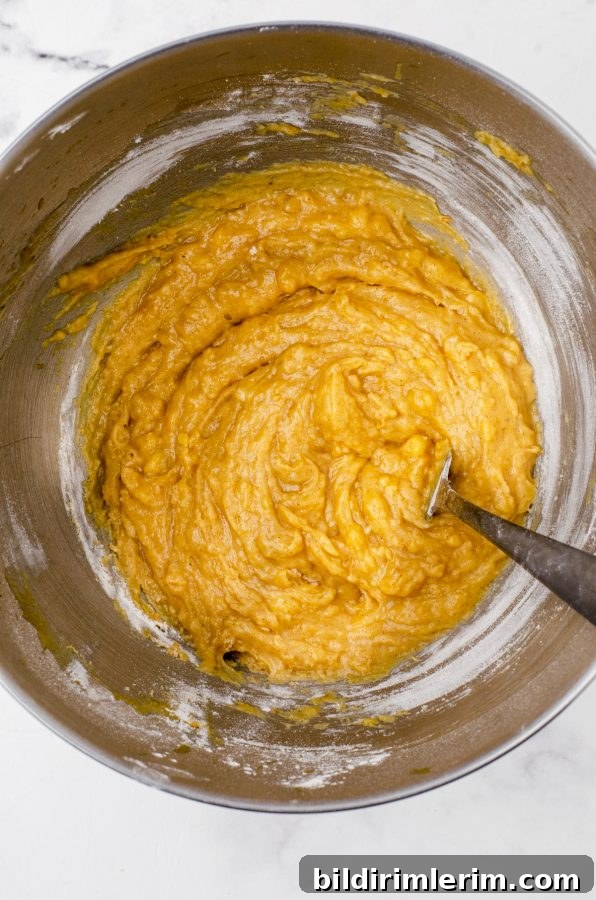 Pumpkin Banana Muffins Recipe with Cinnamon 7 Pumpkin banana muffin batter in a bowl.