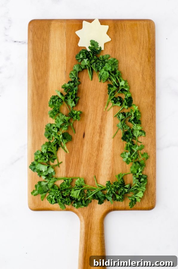 Chopped herbs outlining the tree shape on the charcuterie board