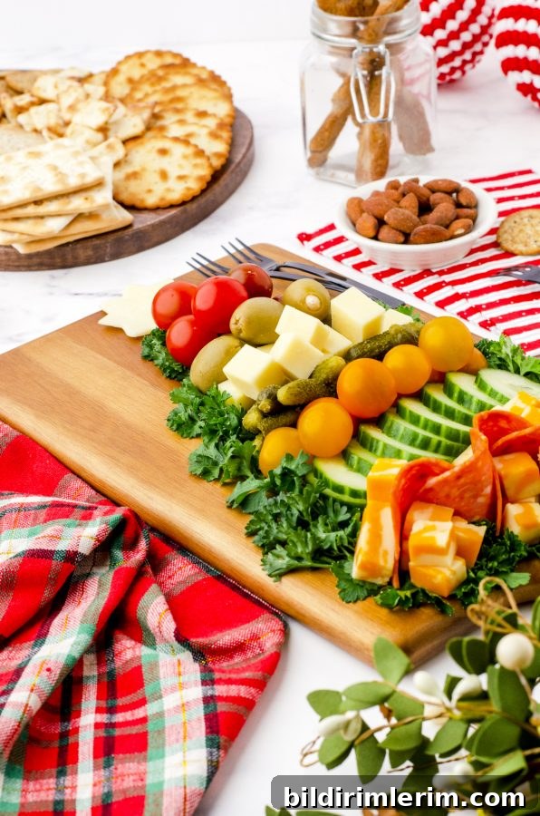 Charcuterie Christmas tree served with crackers and nuts on a table