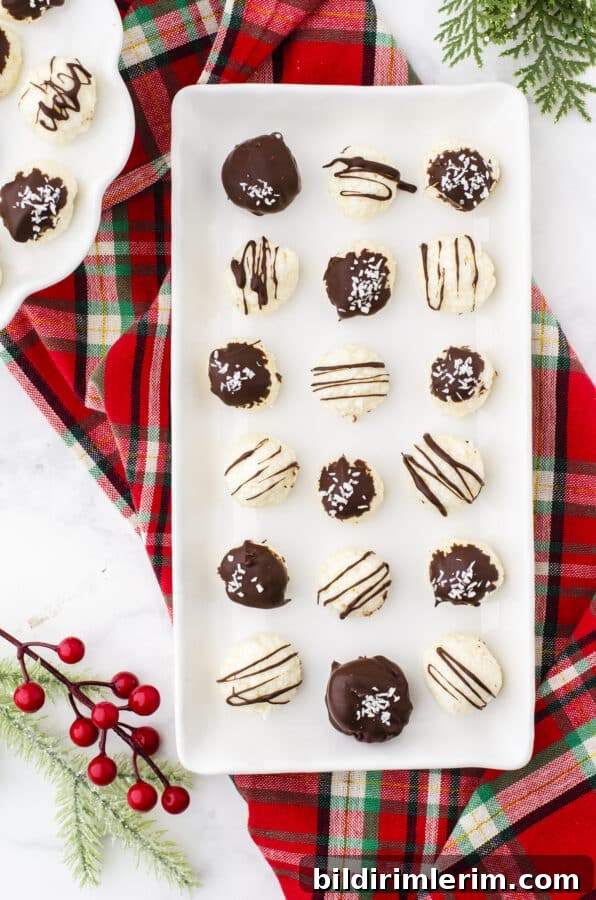 No-Bake Coconut Bliss Balls Recipe 2 Platter of coconut balls covered with chocolate drizzles and coconut.