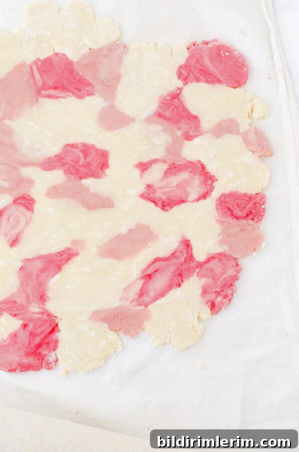Marbled dough rolled out with parchment