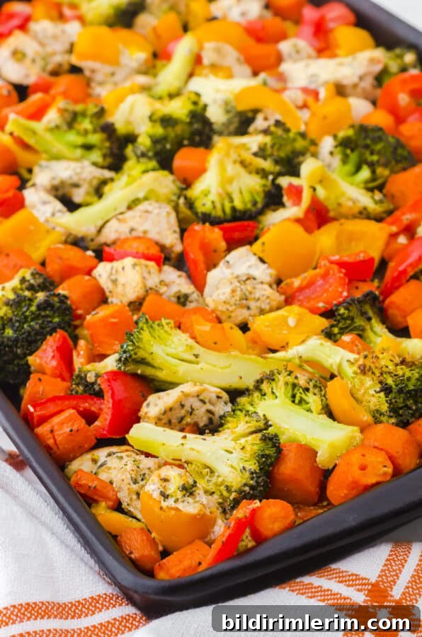 Chicken vegetable sheet pan dinner in a sheet pan.