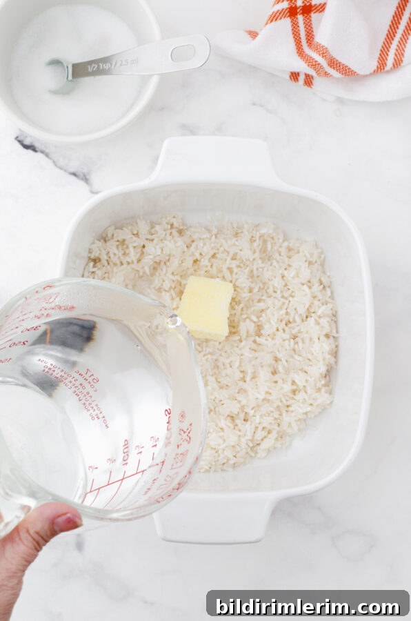 pouring boiling water on to a casserole dish of long grain white rice
