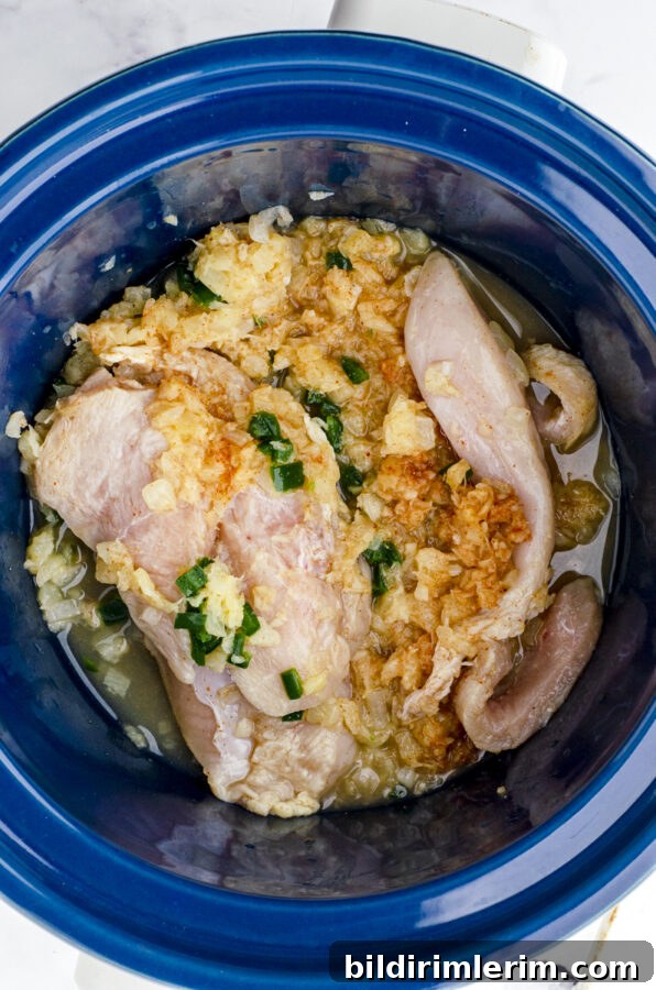 Hawaiian Crock Pot shredded chicken ingredients in a crock pot before they are cooked.