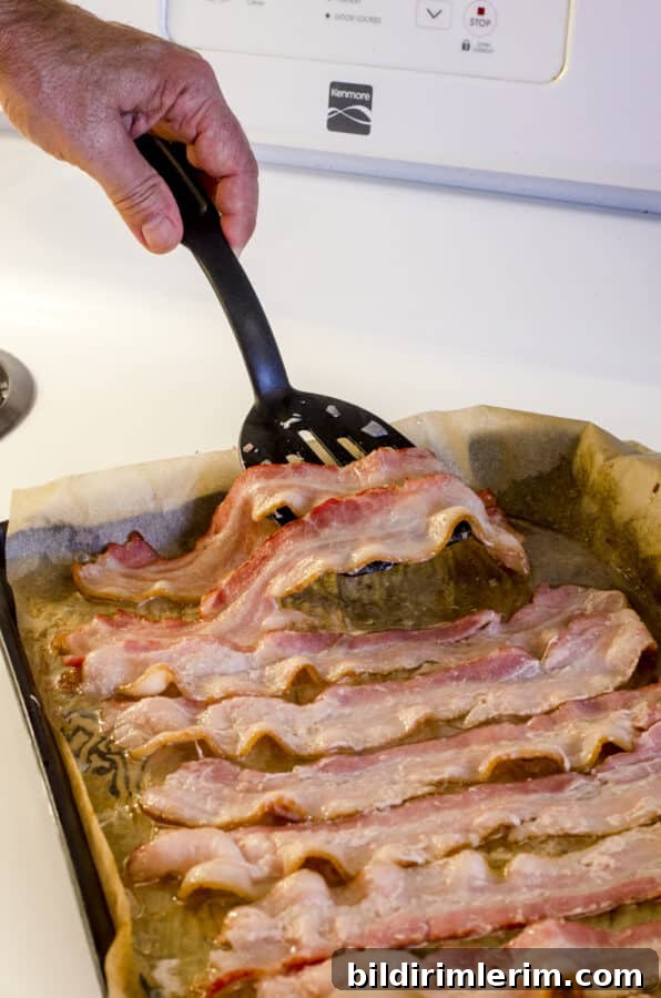 How to Make Crispy Bacon in the Oven Every Time 6 Flip bacon after eight minutes.