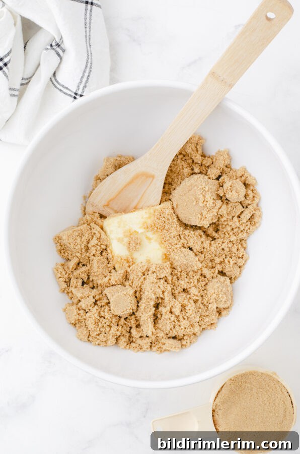 Soft, Chewy Butterscotch Blondies Recipe 5 a big white mixing bowl with brown sugar and butter in it for chewy butterscotch brownies recipe