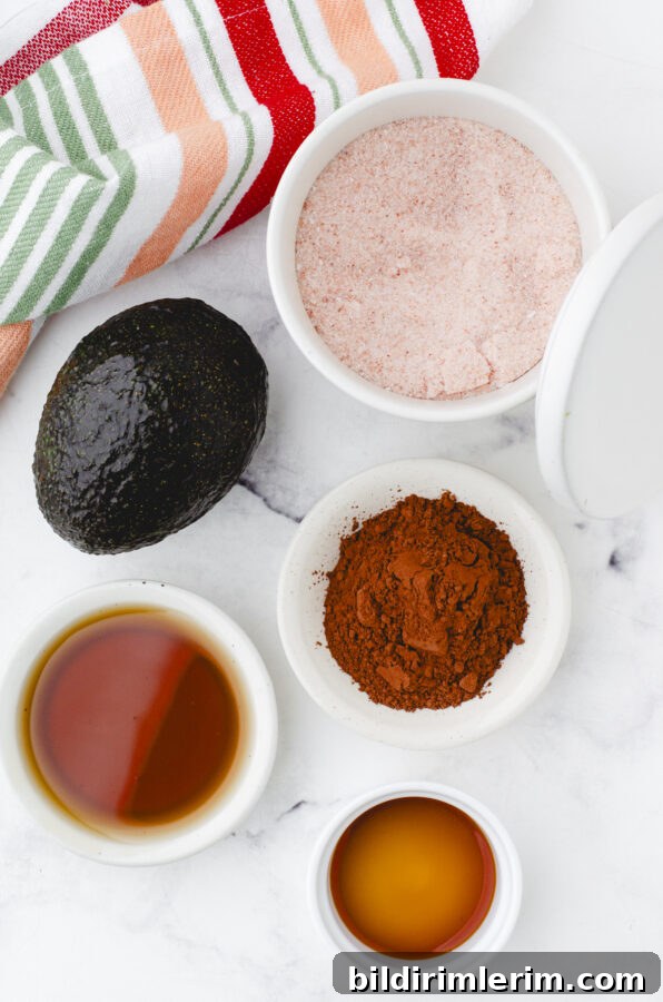 ingredients for chocolate avocado pudding with maple syrup and unsweetened cocoa powder