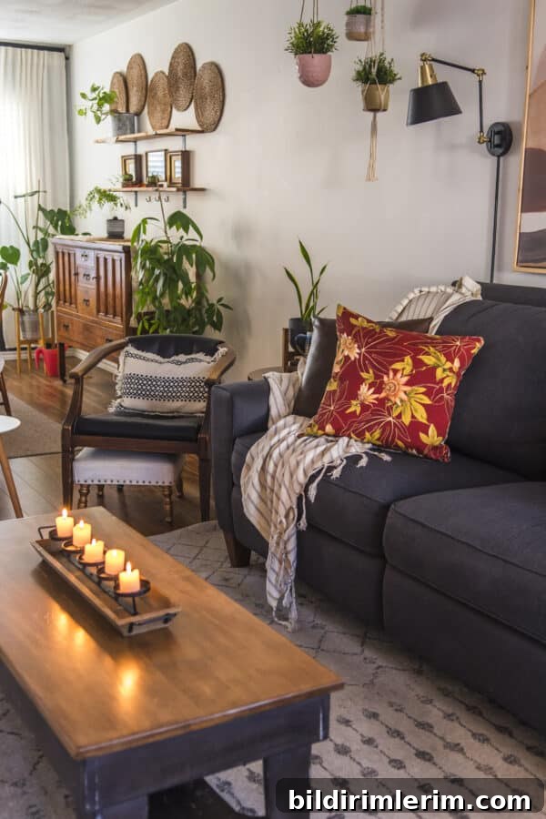 fall pillow cover on a couch with candles on a coffee table in front of it for a boho fall decor look