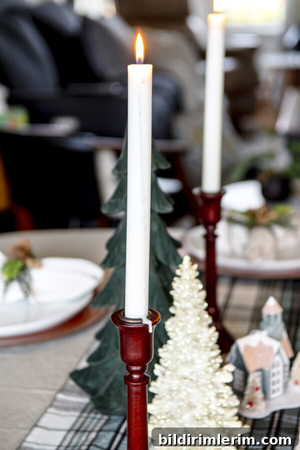 2 taper candles with a green velvet tree in between to make a centerpiece for a Christmas tablescape