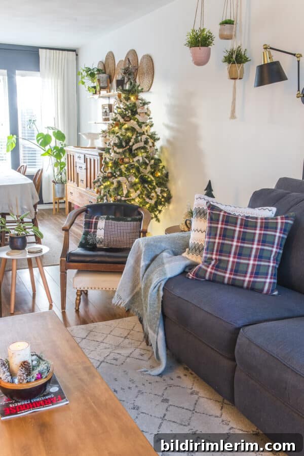 flannel pillow on a couch with a Christmas tree in the background showing some simple Christmas decor ideas.