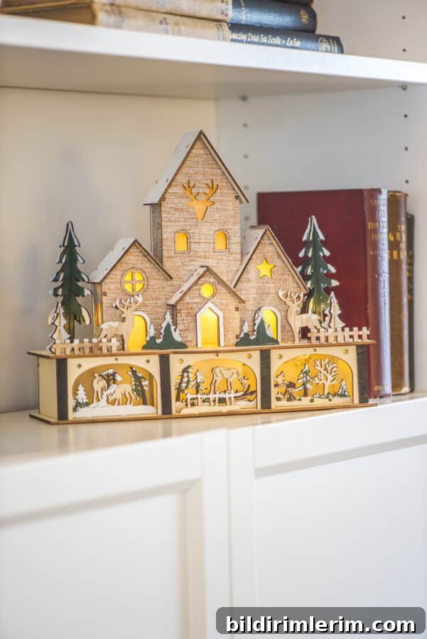 a light up wooden house in a bookcase