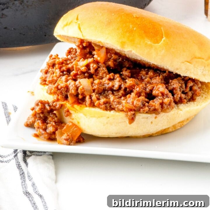 Classic old fashioned sloppy joes recipe in a bun on a serving plate