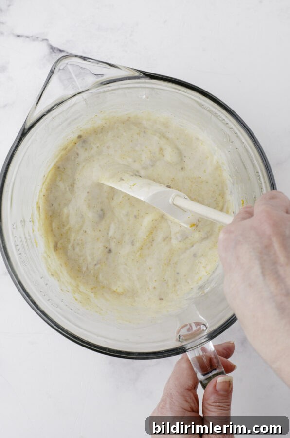 Chicken divan sauce ingredients are mixed in a mixing bowl