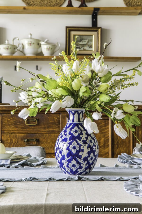 Ginger jar vase with faux tulip arrangment on a table top