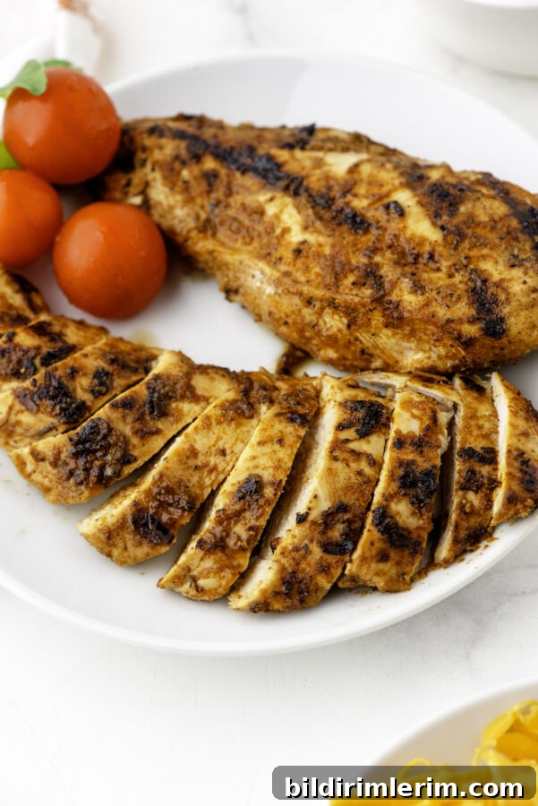 A plate of cooked, sliced Mexican chicken breasts.