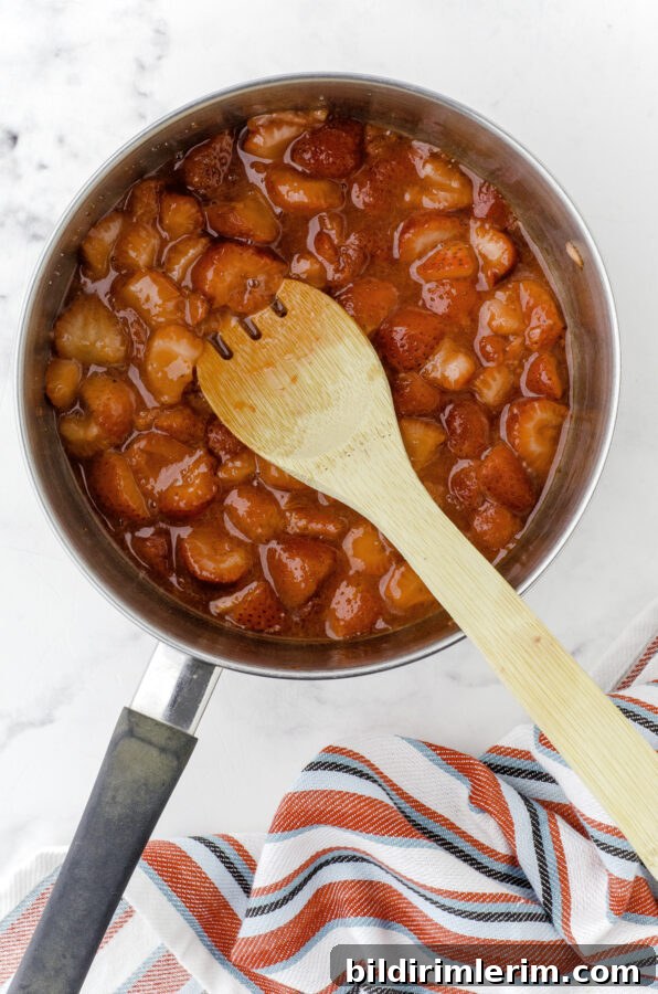 Strawberry sauce cooking in saucepan