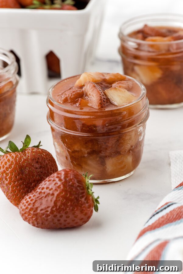 Jar of cooked strawberry sauce
