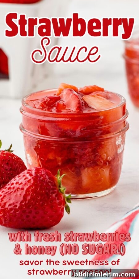 Jar of strawberry sauce with fresh berries