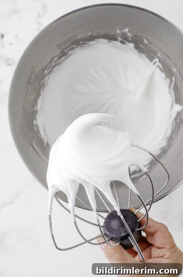 Meringue with a glossy peak on the whisk