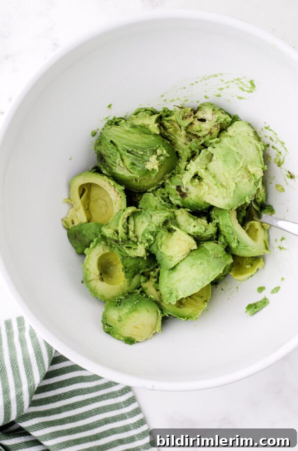 Avocado halves in a large bowl.