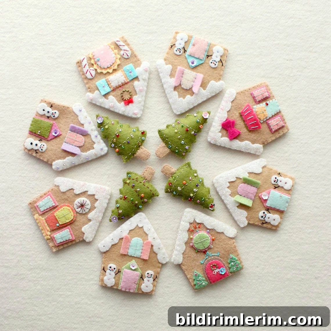 Felt gingerbread houses and trees arranged in a circle like a wreath