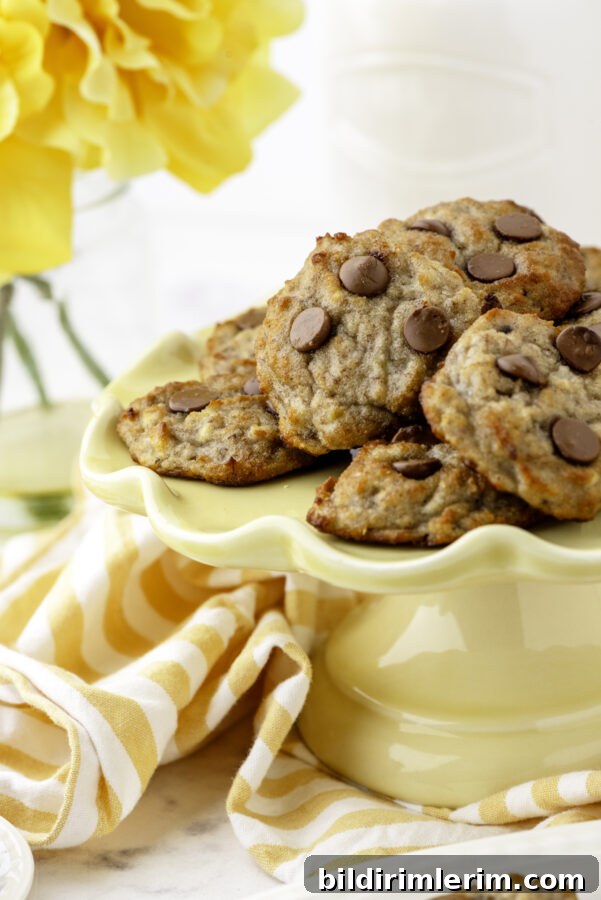 Mini Banana Bread Cookie Bites Recipe 2 A yellow cake platter with a pile of 2-bite banana bread cookies on it.
