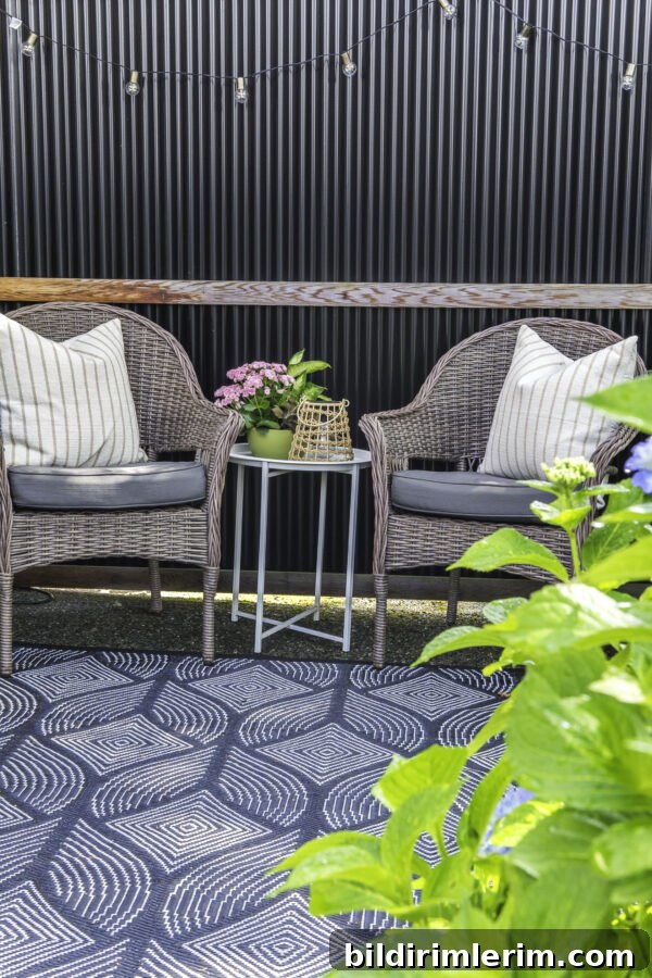 2 patio chairs on a patio with a side table between them.