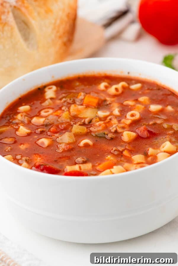 Classic Italian Minestrone Soup Recipe 2 A bowl of Minestrone Italian Soup with fresh sour dough bread behind.