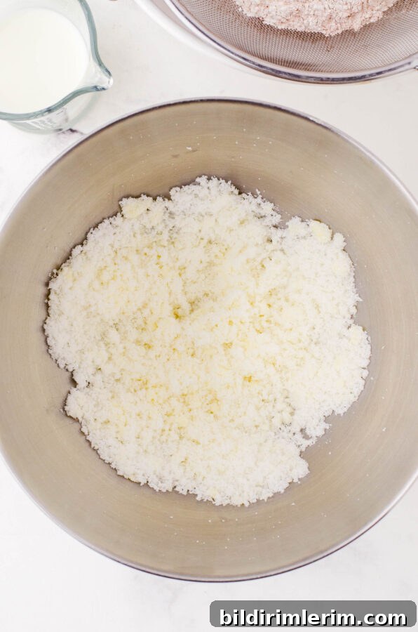 Butter and sugar creamed together in a stand mixer bowl.