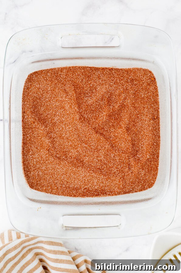 Topping mix on a pan of chocolate pudding cake batter.