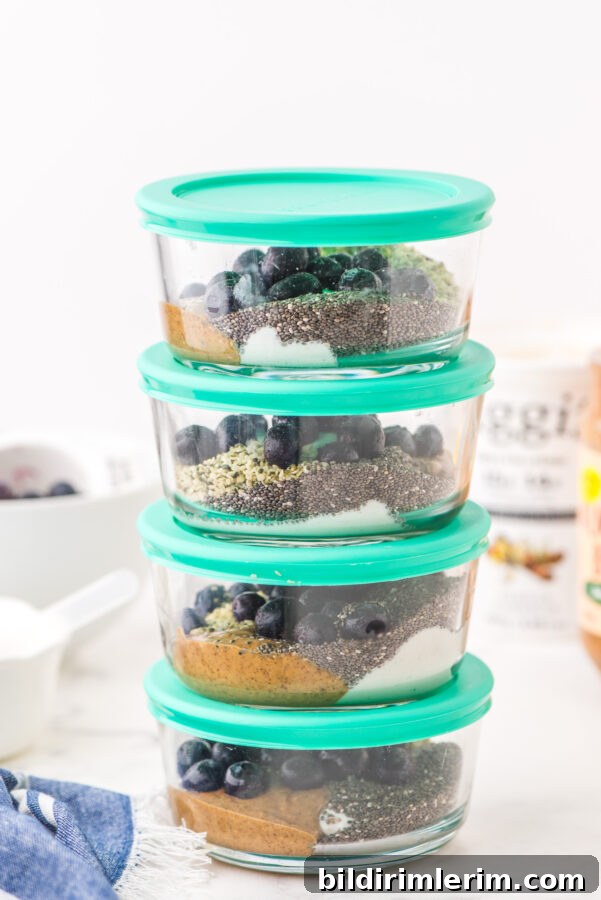Make-Ahead Yogurt Bowls for Quick Grab-and-Go Breakfasts 2 A stack of yogurt bowls with green lids.