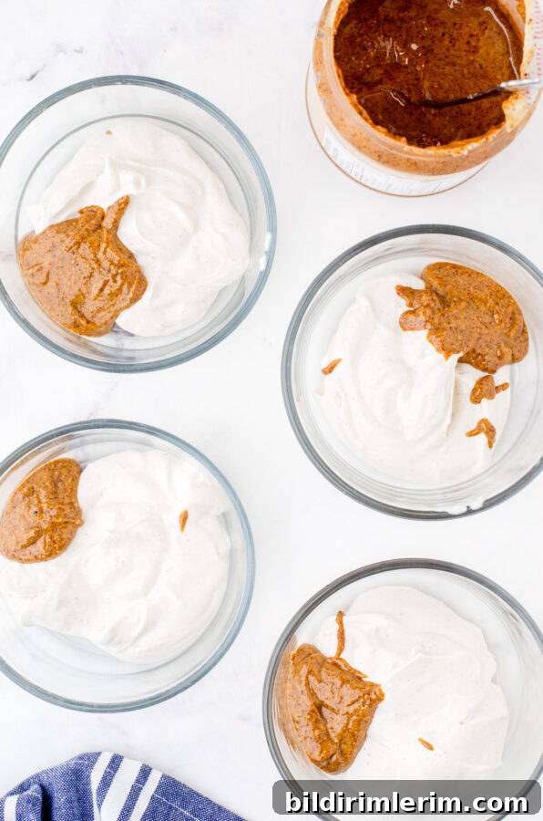 Make-Ahead Yogurt Bowls for Quick Grab-and-Go Breakfasts 5 4 serving bowls with a serving of greek yogurt and almond butter in each one.