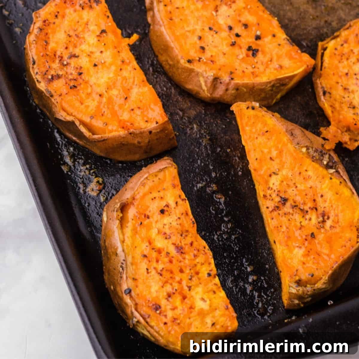 Roasted sweet potatoes on a pan.