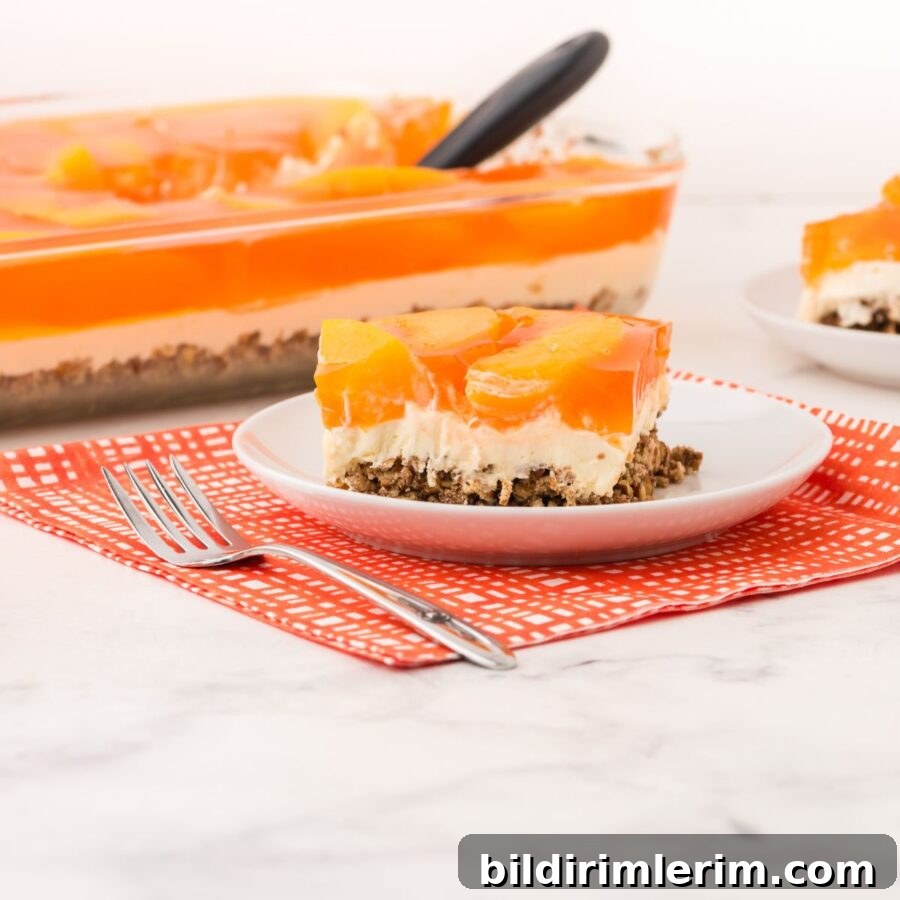 A slice of peach pretzel salad on a serving plate.
